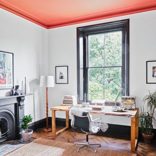 Home office with desk and chair and terracotta painted ceiling