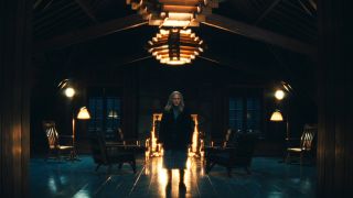 Harmony Cobel standing in a dimly lit birthing cabin in Severance season 2 episode 9