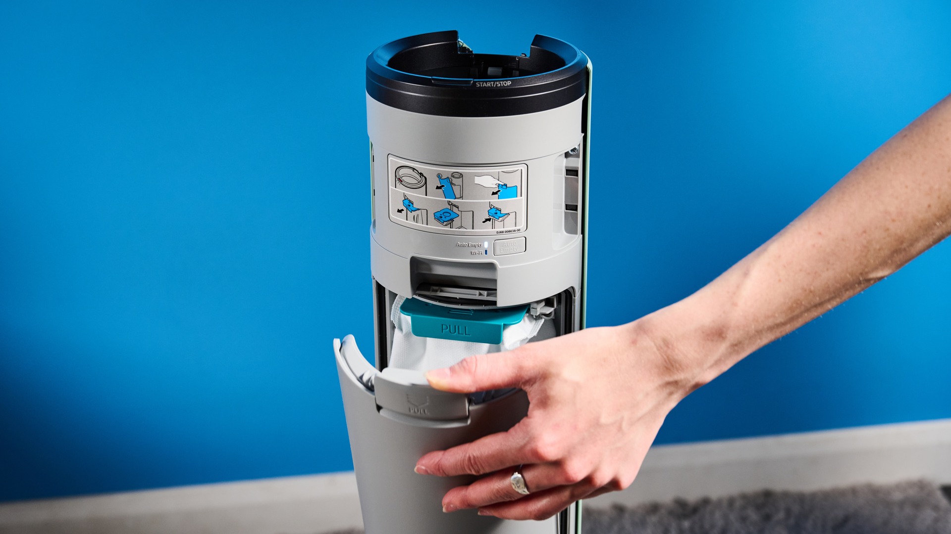 the samsung bespoke jet AI vacuum cleaner in mint green against a blue background, showing its ability to clean carpets and baseboards, as both a stick and a handheld