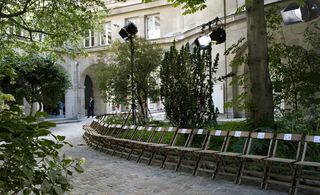 Catwalk was arranged in the garden's pathways, lined by rows of chairs.