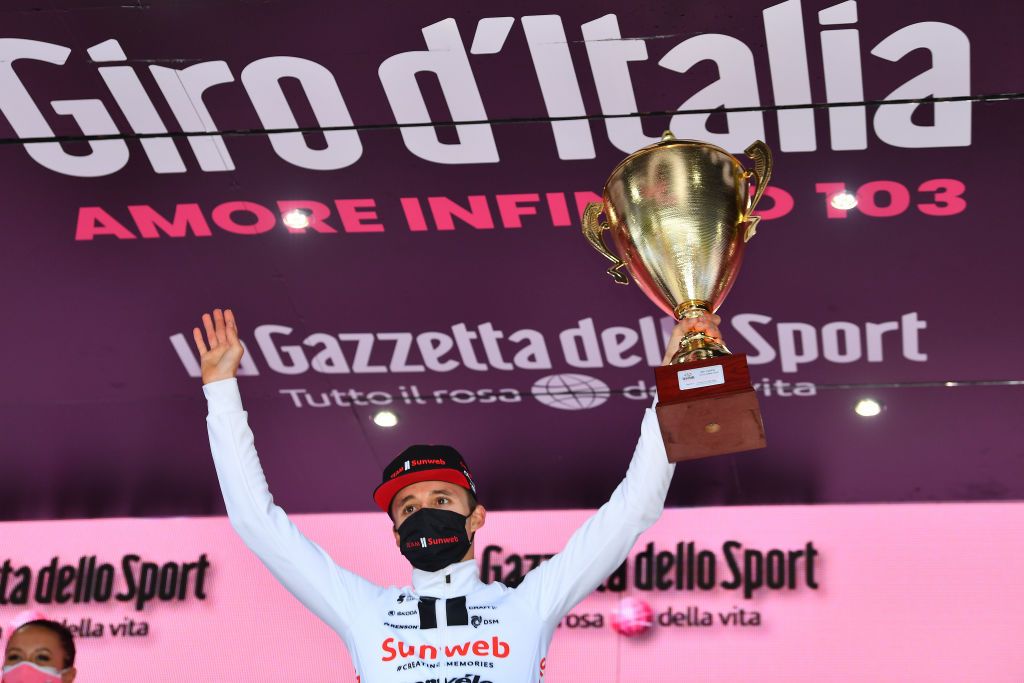LAGHI DI CANCANO ITALY OCTOBER 22 Podium Jai Hindley of Australia and Team Sunweb Celebration Stelvio Trophy Mask Covid safety measures during the 103rd Giro dItalia 2020 Stage 18 a 207km stage from Pinzolo to Laghi di Cancano Parco Nazionale dello Stelvio 1945m girodiitalia Giro on October 22 2020 in Laghi di Cancano Italy Photo by Stuart FranklinGetty Images
