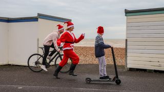 Family in Santa hats on the seafront