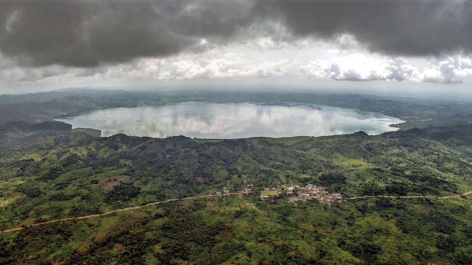 A photo of the lake from a low-flying plane with dark clouds overhead