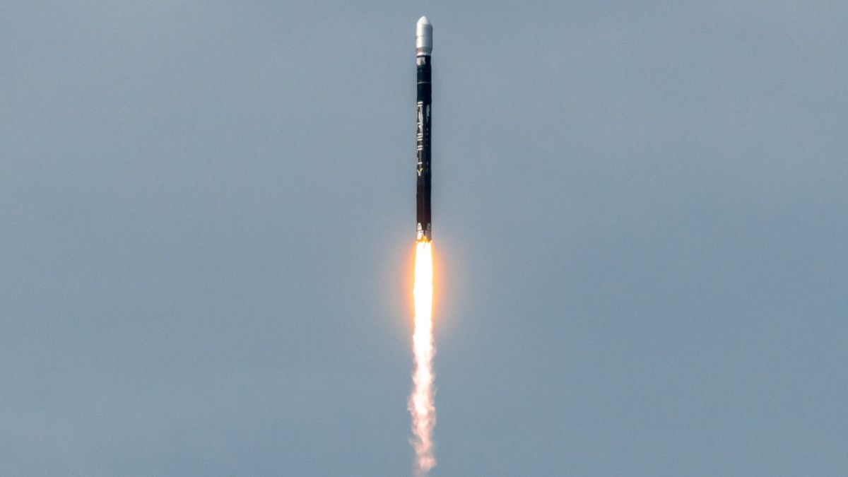 A black Firefly Aerospace rocket launches into a blue sky.