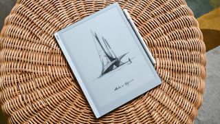 The Onyx Boox Go 10.3 e-ink writing tablet and its stylus on a wicker stool