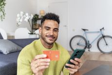 Bank switching deals young man with phone and card