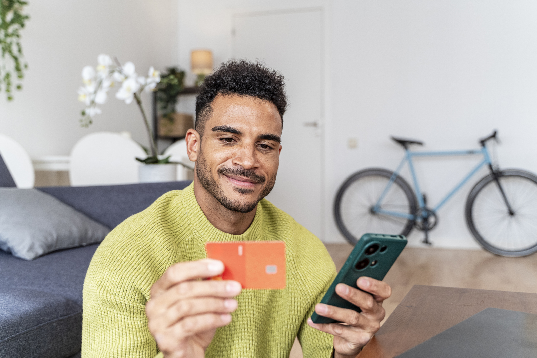 Bank switching deals young man with phone and card