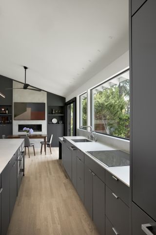 A long kitchen counter with a sink