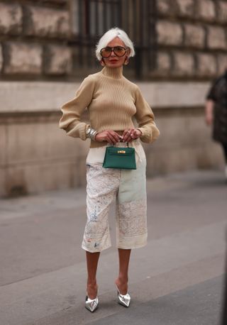 woman wearing cream bermuda shorts with beige turtleneck