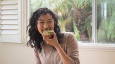 Woman eating an avocado