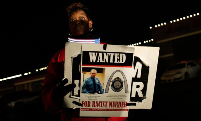 A protester calls for punishment for Darren Wilson