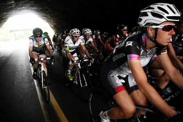 Providing some shade the peloton cools their cleats in the tunnel.