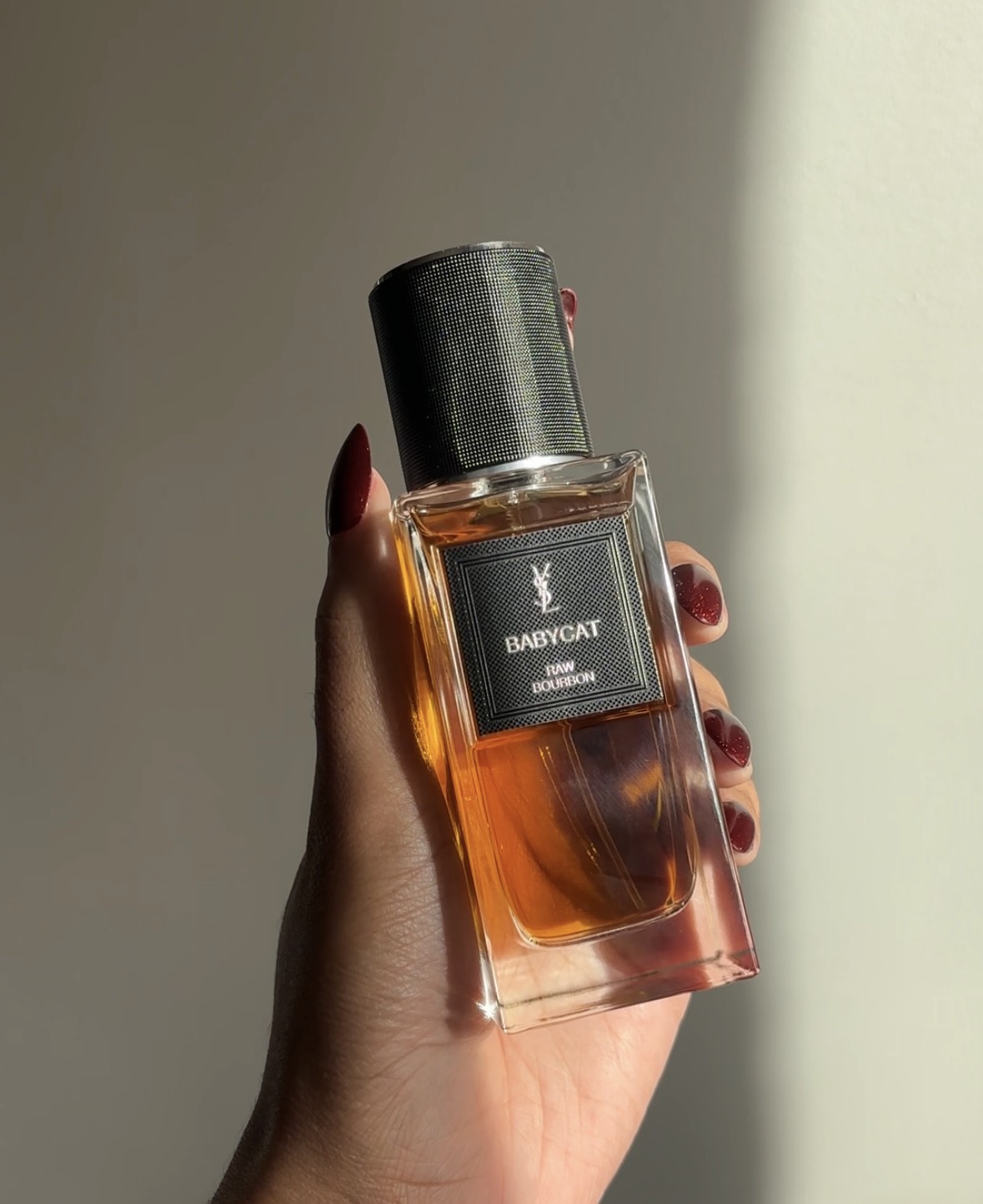 bottle of yves saint laurent fragrance, held by the author