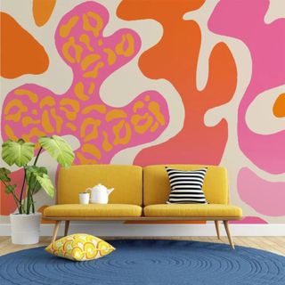 Bright orange and pink wallpaper in a whimsical living room