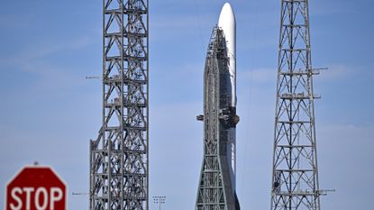 a photo of Blue Origin's New Glenn rocket with a "stop" sign visible in the foreground