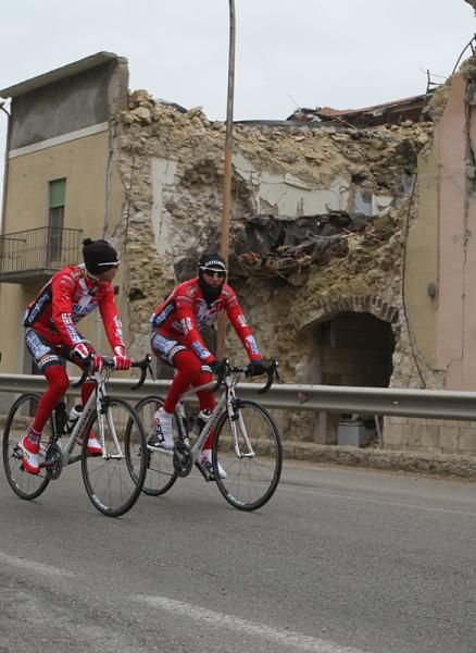 The team passes more destroyed buildings