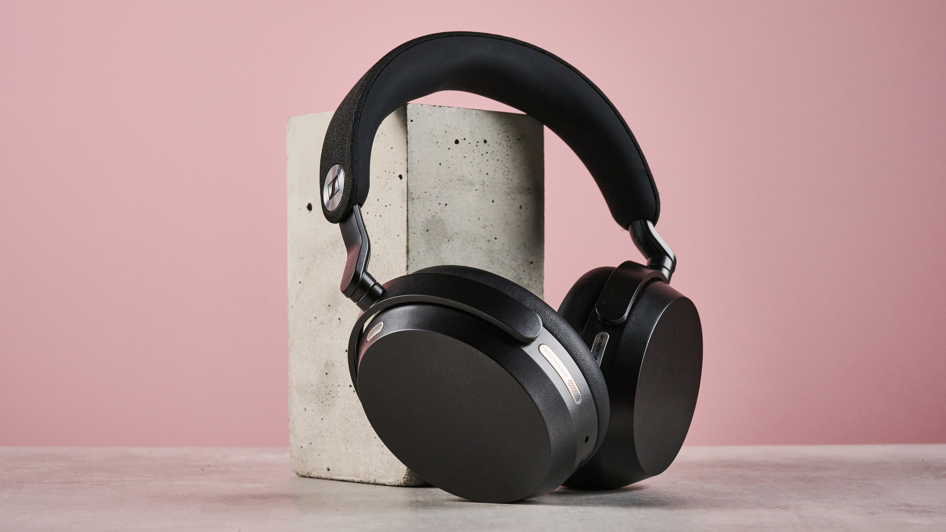 The Sennheiser Momentum 5 leaning against another concrete block.