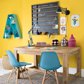 yellow office room with table and blue chairs