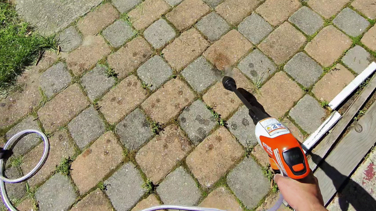 Stihl REA 100 Plus removing weeds from pavers.
