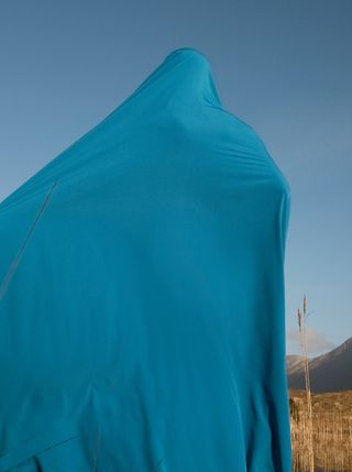 A person wrapped in blue fabric.