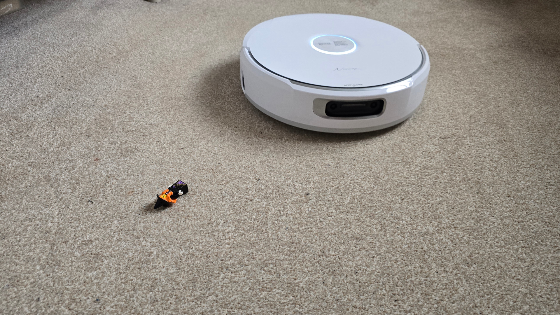Narwal Flow avoiding Lego figure on carpet