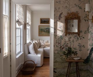 summer living room with a curated doorway vignette and floral wallpaper