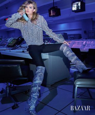 Gigi Hadid poses in a launch control center scene at NASA's Kennedy Space Center in Florida during a visit for a photo shoot with Harper's Bazaar.