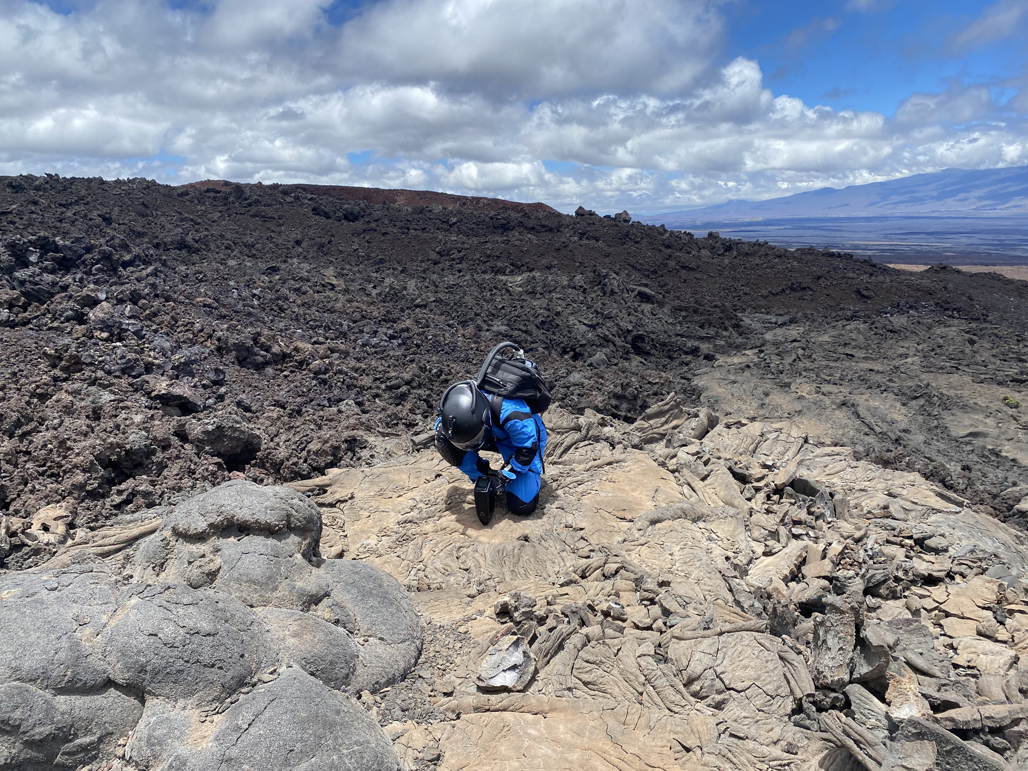 Nance takes SciAps Laser Induced Breakdown Spectrometer (LIBS) measurements of lava rocks during a Marswalk.