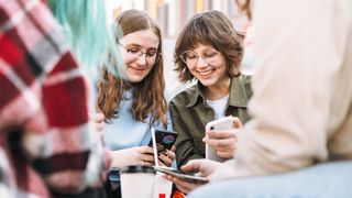 Teen kids looking at smartphones