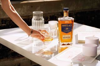 Hand reaching for Mortlach whisky