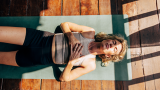 Woman lying on mat during workout