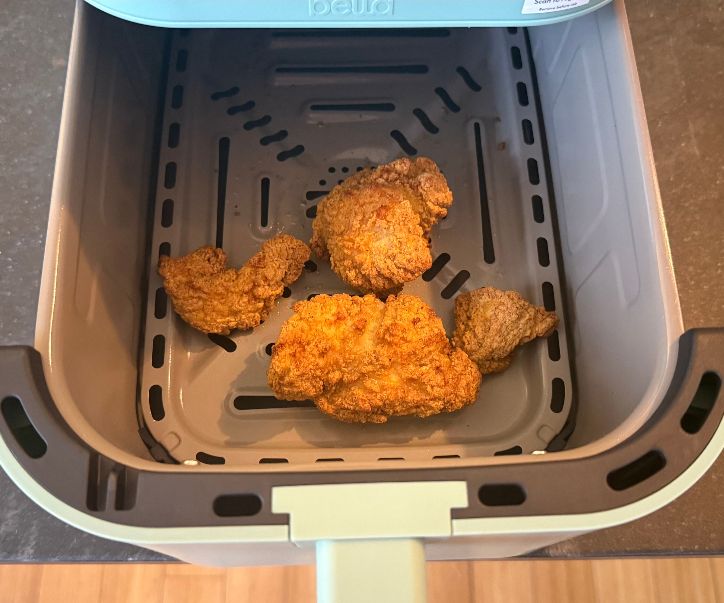 Fried chicken in the Bella FitsAnywhere 4QT Air Fryer in the test kitchen