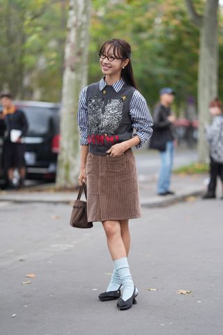 woman wearing a round sweater vest