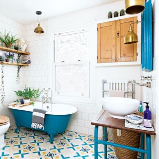 bathroom with white tiles wall and shelf and washbasin and blue bathtub