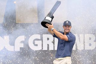 Bryson DeChambeau hoists a LIV Golf trophy in the air