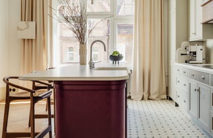 A kitchen with patterned floor tiles