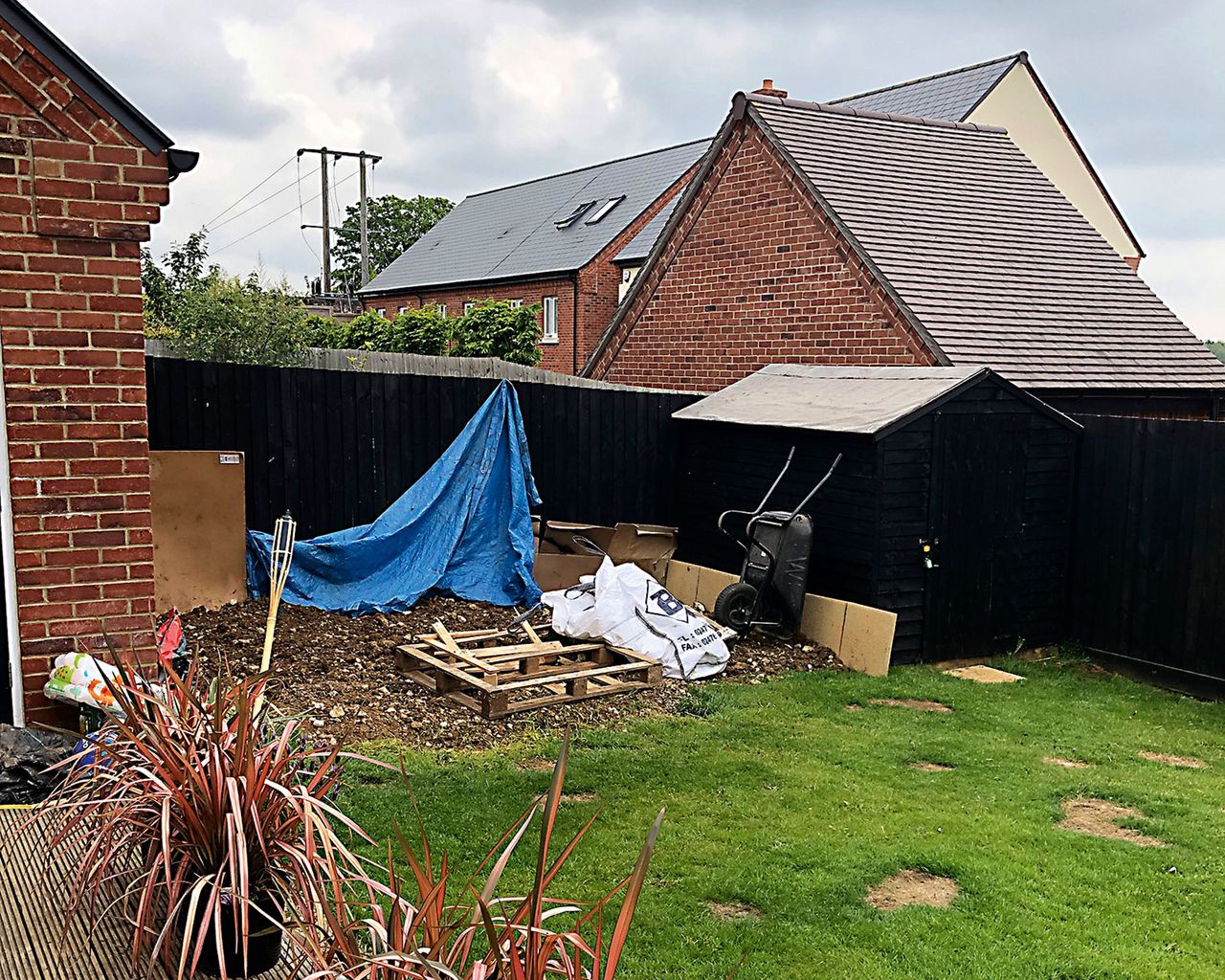 the befre shot of a disused area of a garden to become a decked patio area