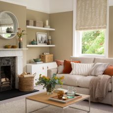 Cosy living room with fireplace, circle mirror and alcove storage