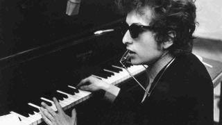 Bob Dylan playing the piano in the recording studio in 1965