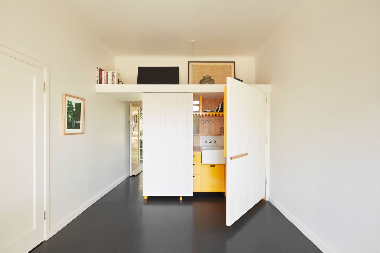 a fold away kitchen in a studio apartment