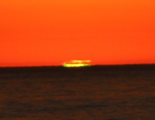 The second of two green flashes appears in this cropped, full-resolution image from a sunset off Solano Beach Ca. Josh Knutson took this image on Oct. 27, 2012 using a Canon T3i and 300mm EF lens in HD Video mode. The image was taken in the middle of the video sequence on full auto settings.