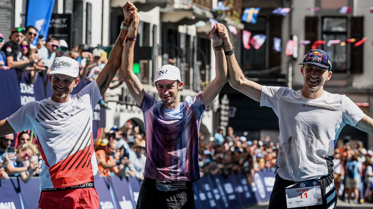 second placed France&#039;s Mathieu Blanchard (L), winner Spain&#039;s Kilian Jornet (C), and third placed Britains Thomas Evans (R) celebrate on the podium of 19th edition of the Ultra Trail du Mont Blanc 