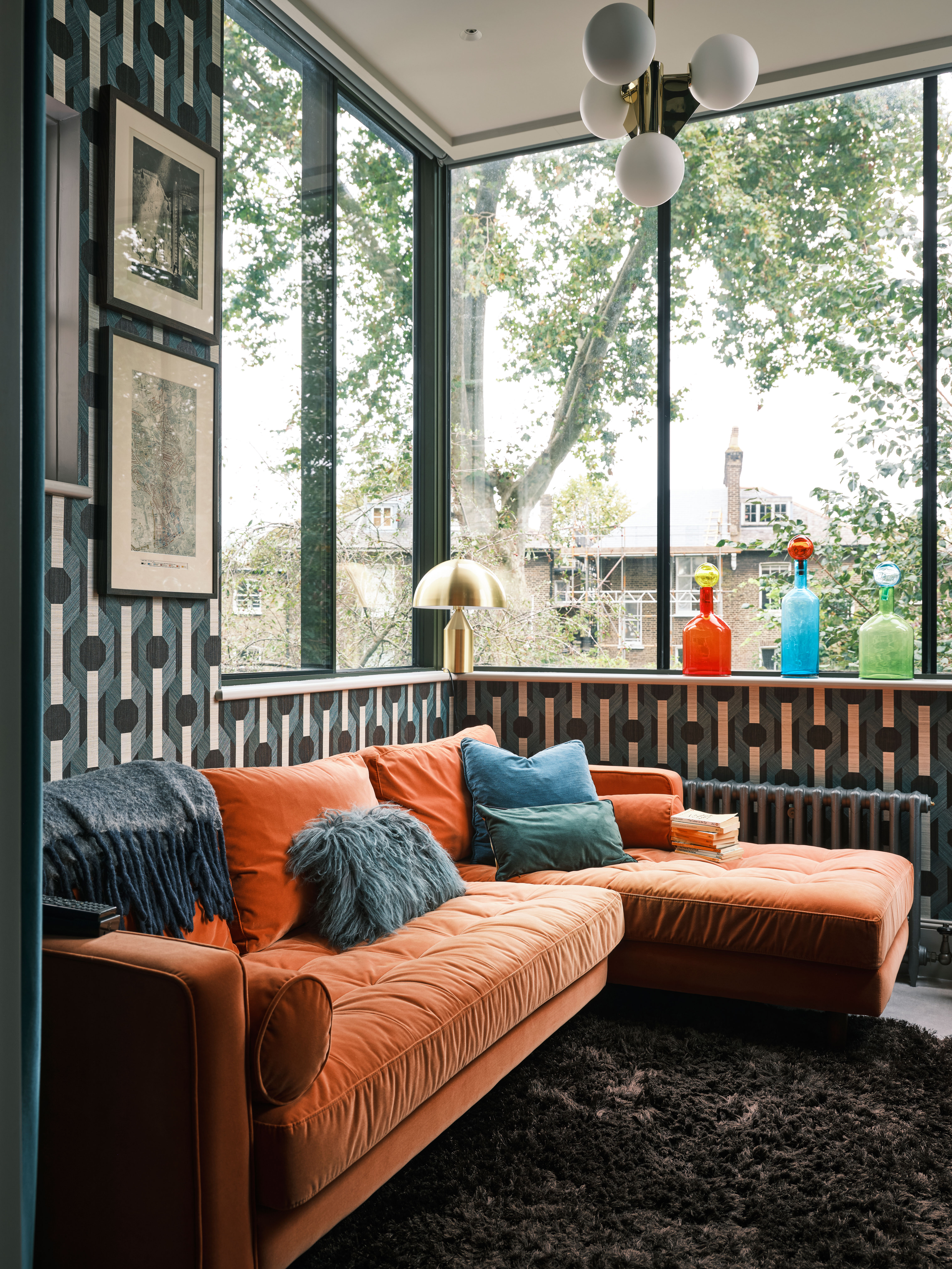 small sunroom with orange corner sofa