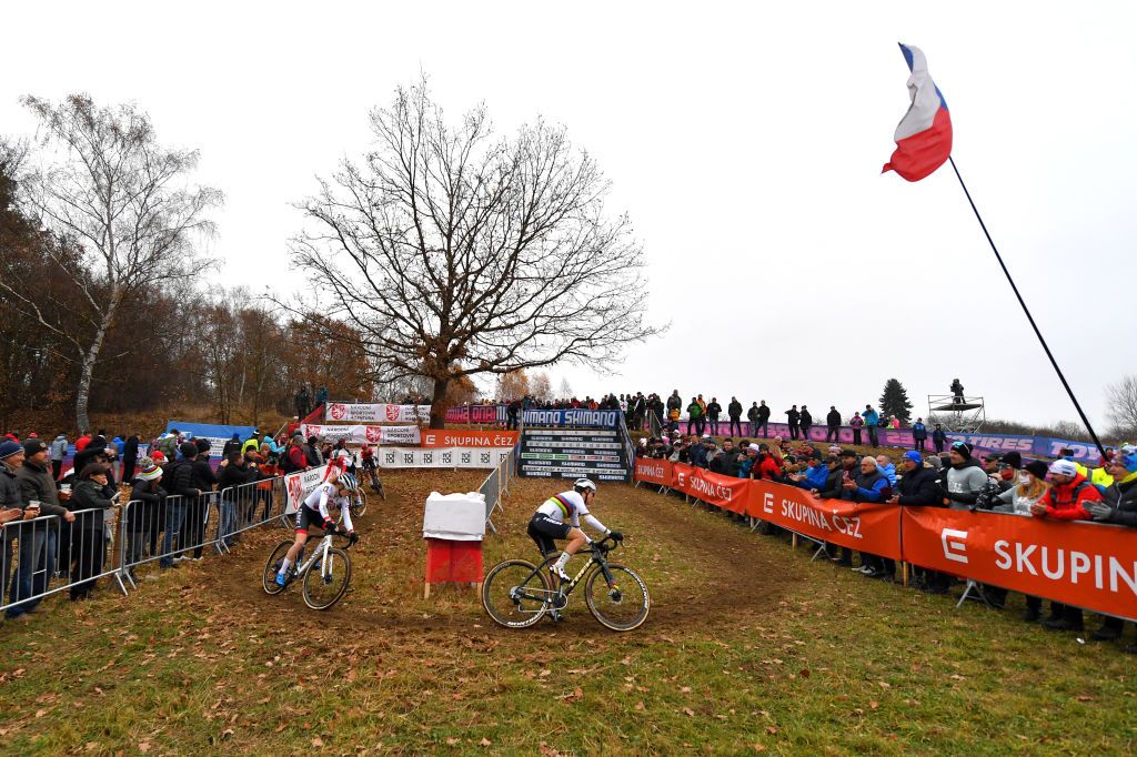TABOR CZECH REPUBLIC NOVEMBER 14 LR Puck Pieterse of The Netherlands and Team AlpecinFenix and Lucinda Brand of The Netherland and Team Baloise Trek Lions compete while fans cheer during the 25th Tabor UCI CycloCross Worldcup 2021 Womens Elite CXWorldCup on November 14 2021 in Tabor Czech Republic Photo by Luc ClaessenGetty Images