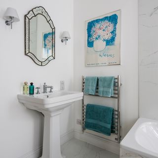 en suite bathroom with white walls and washbasin
