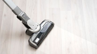 The best vacuum for hard floors cut through dirt. A close up of a vacuum cleaning a hard floor
