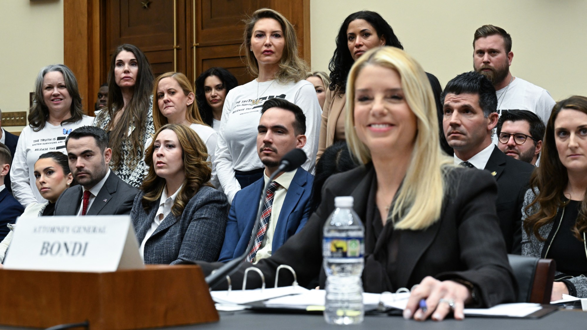 TOPSHOT - Victims of convicted sex offender Jeffrey Epstein react as US Attorney General Pam Bondi testifies before a House Judiciary Committee hearing on "Oversight of the Department of Justice" on Capitol Hill in Washington, DC, on February 11, 2026. (Photo by ROBERTO SCHMIDT / AFP via Getty Images)