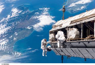 Backdropped by New Zealand and Cook Strait in the Pacific Ocean, astronaut Robert L. Curbeam Jr. (left) and European Space Agency (ESA) astronaut Christer Fuglesang, both STS-116 mission specialists, participate in the mission's first of three planned ses