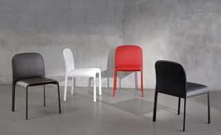 Four round-edged 'Scala' chairs in black, white and red.