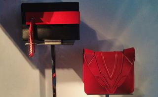 Installation of black and red handbags